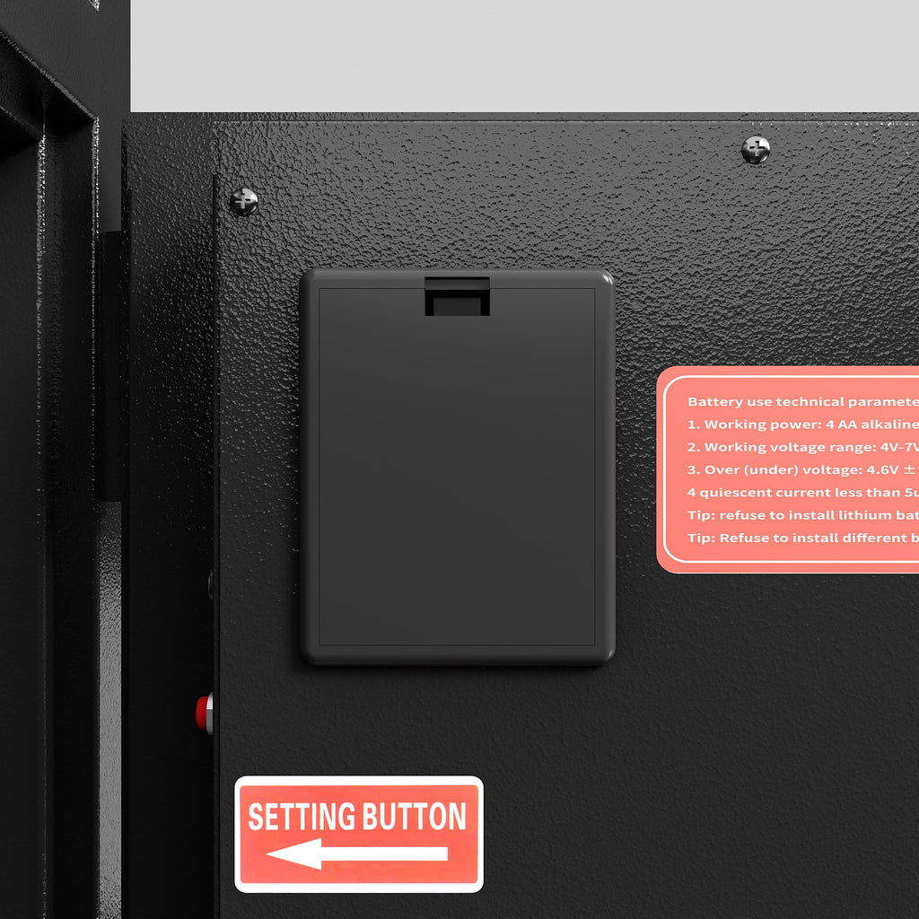 Close-up of a black carbon steel digital safe box showing the setting button and battery compartment