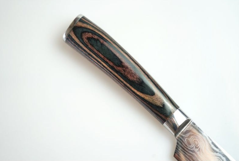 Close-up of carpenter's chef knife 8 piece set with detailed wooden handle and sharp blade
