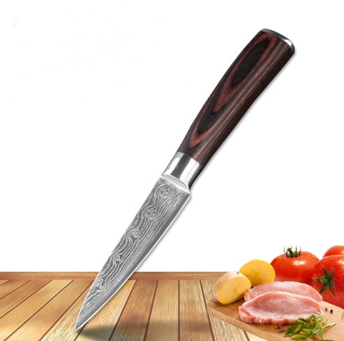 Shopi Vella carpenter's chef knife 8 piece with patterned blade and wooden handle on cutting board with vegetables and meat