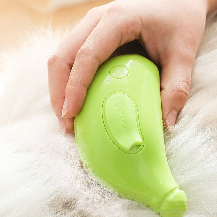 Shopi Vella green cat and dog hair removal comb gently removing pet fur from white fur surface