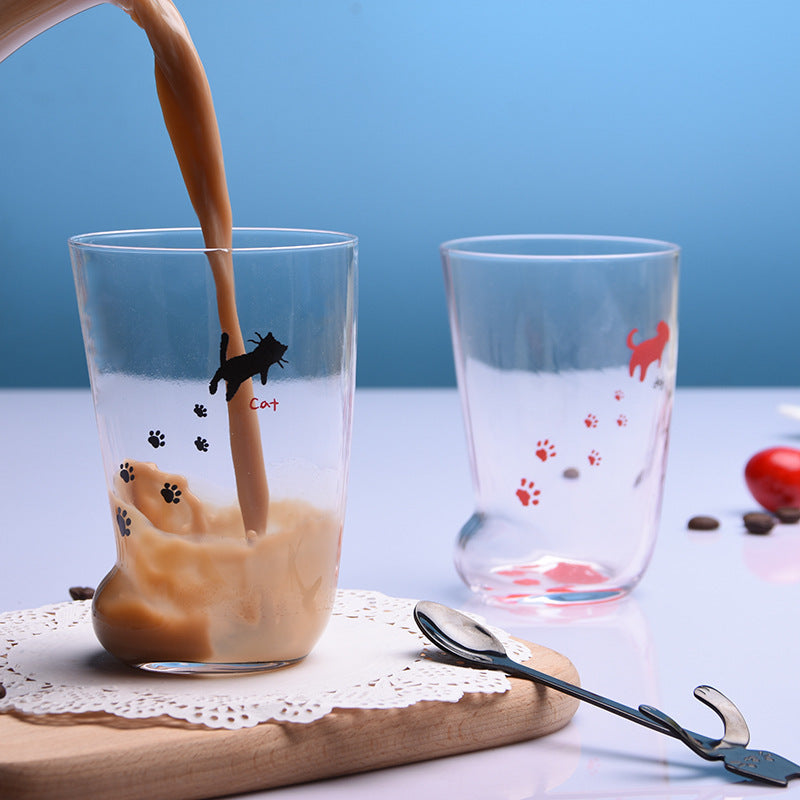 Shopi Vella cat paw tumbler gift with clear glass featuring black and red cat paw prints and a pouring drink