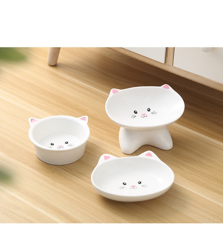 Shopi Vella ceramic cat face pet bowl set in white with pink ear accents on a wooden floor