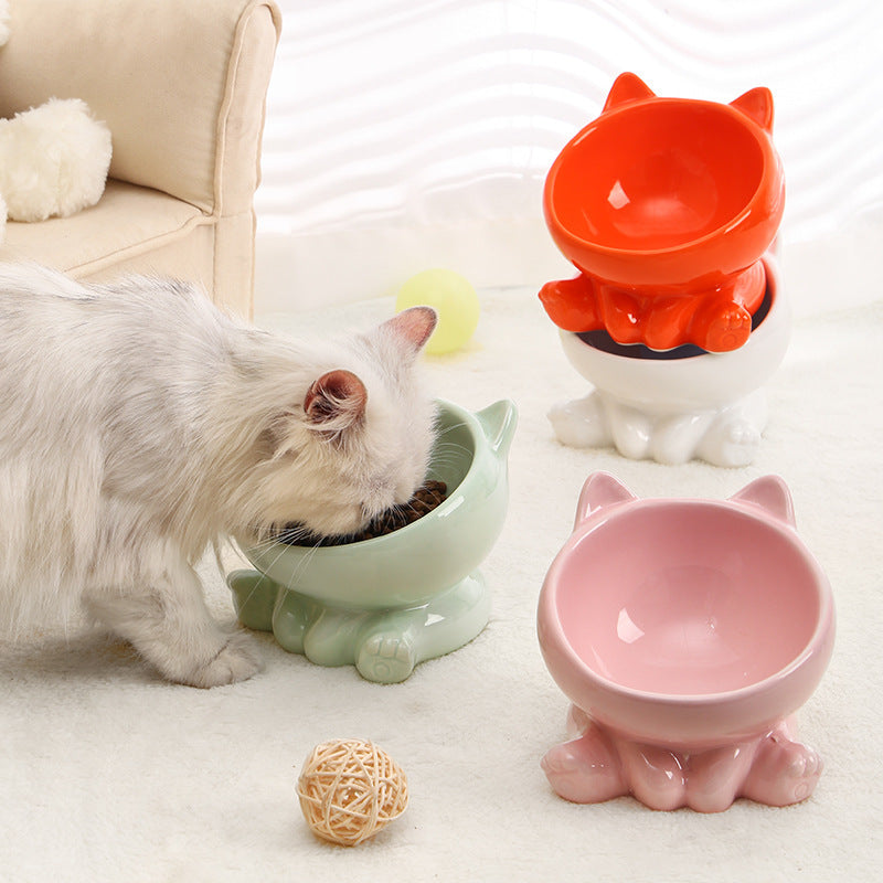 Shopi Vella ceramic cat food bowl set in green pink red and white with cat shape design and a cat eating from the green bowl