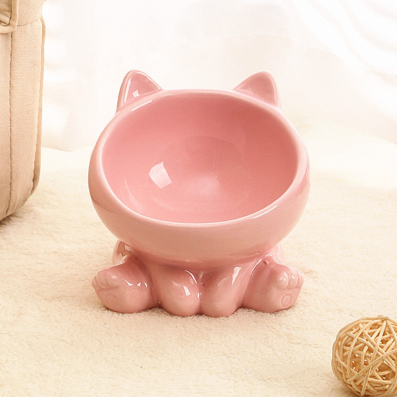 Shopi Vella pink ceramic cat food bowl shaped like a cat with ears and paws on carpet