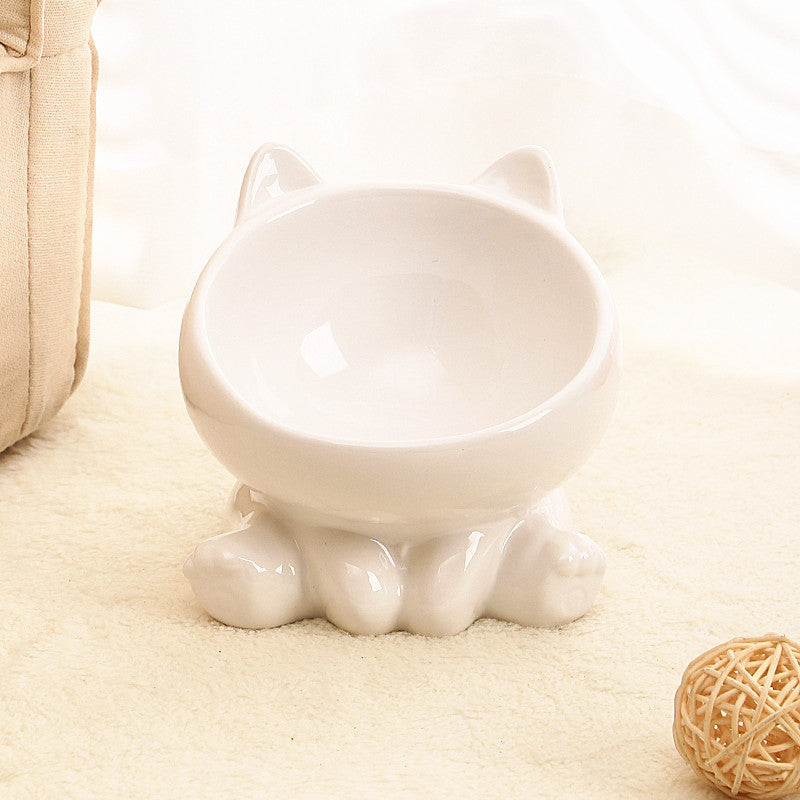 White ceramic cat food bowl shaped like a cat with ears and paws for home storage