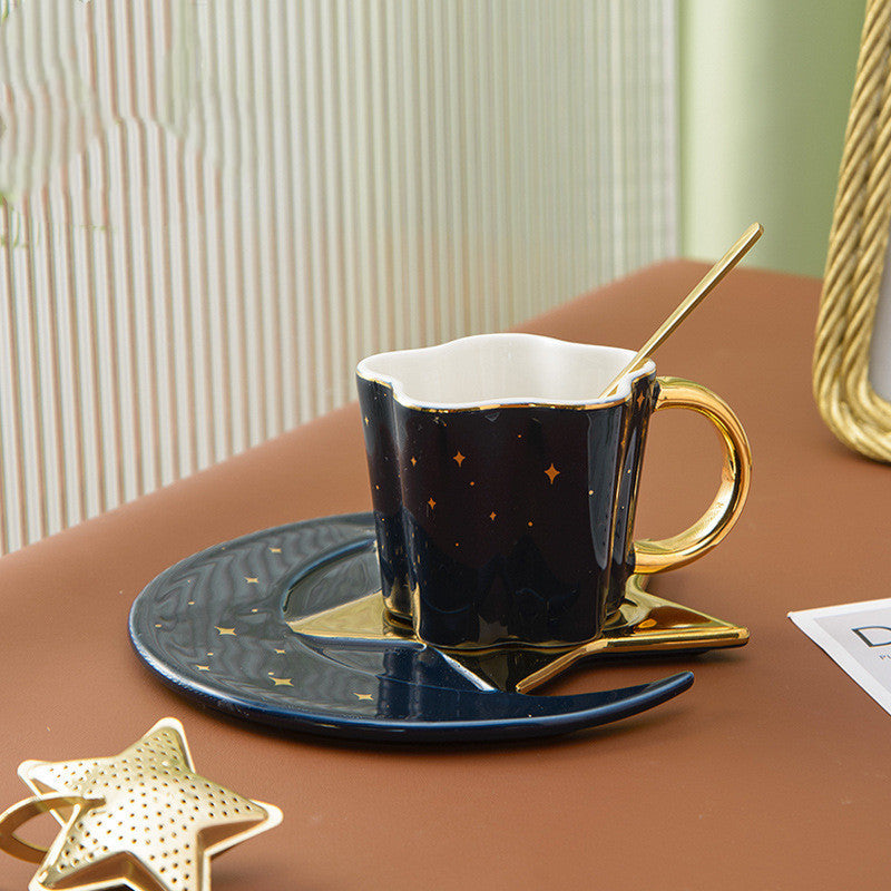 Shopi Vella ceramic cup with star and moon saucer in black and gold with matching spoon