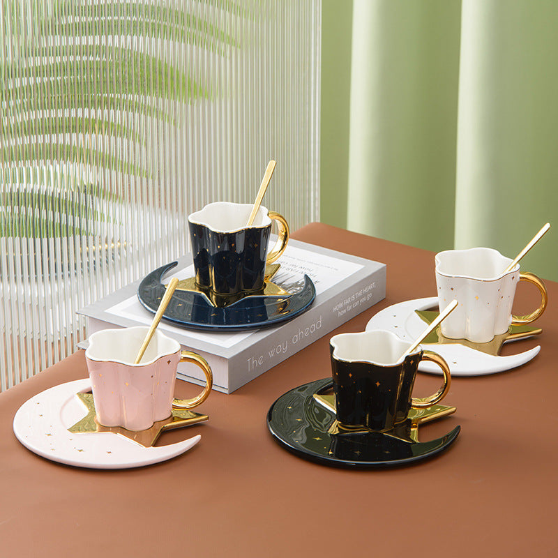Shopi Vella ceramic cup with star and moon saucer set in black, white, and pink with gold handles and spoons