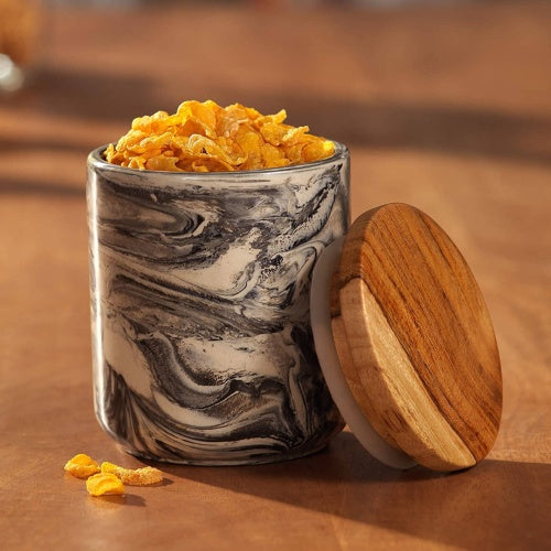 Marbled ceramic jar with wooden lid filled with cereal for kitchen storage