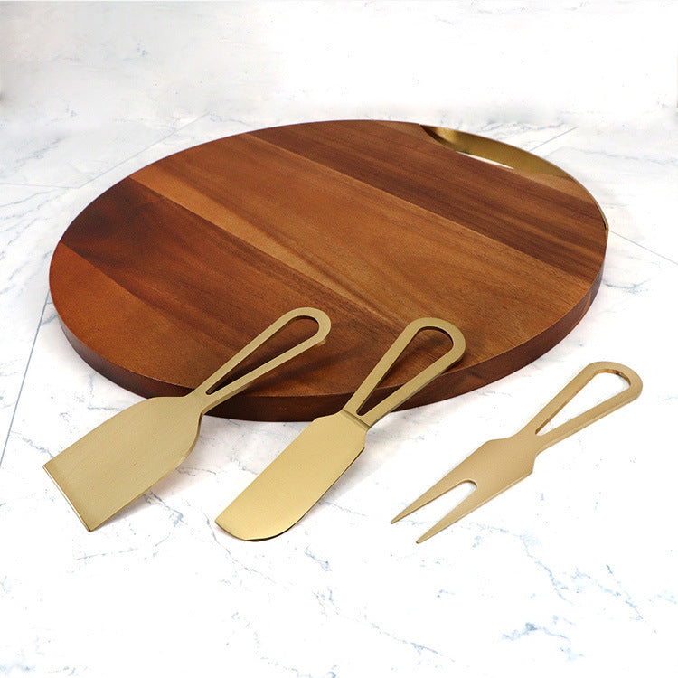 Shopi Vella cheese board and knife set with round wooden board and three gold metal utensils