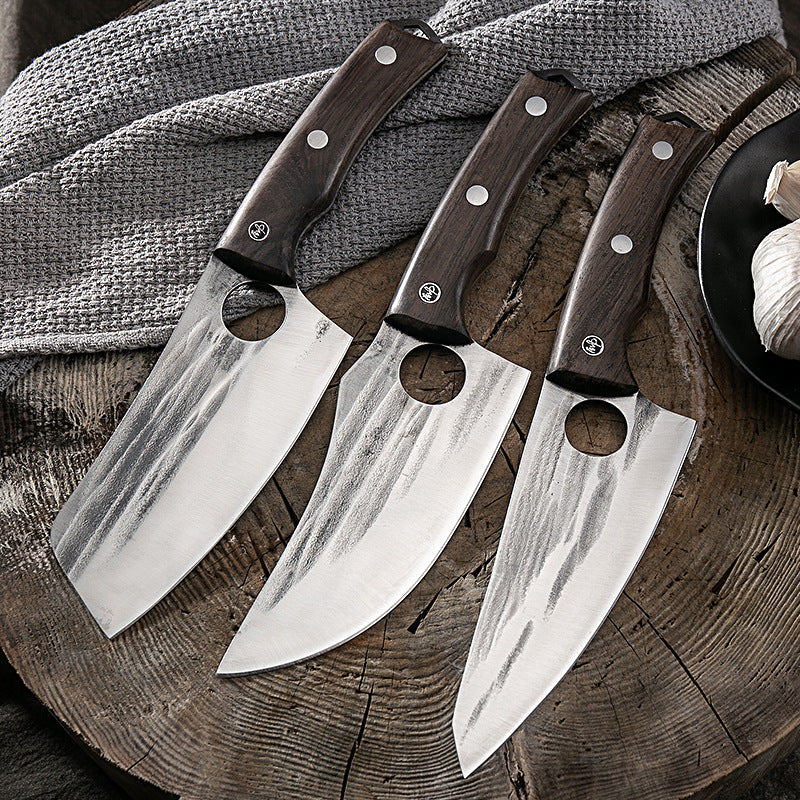 Set of three Shopi Vella kitchen deboning knives with wooden handles on wooden cutting board