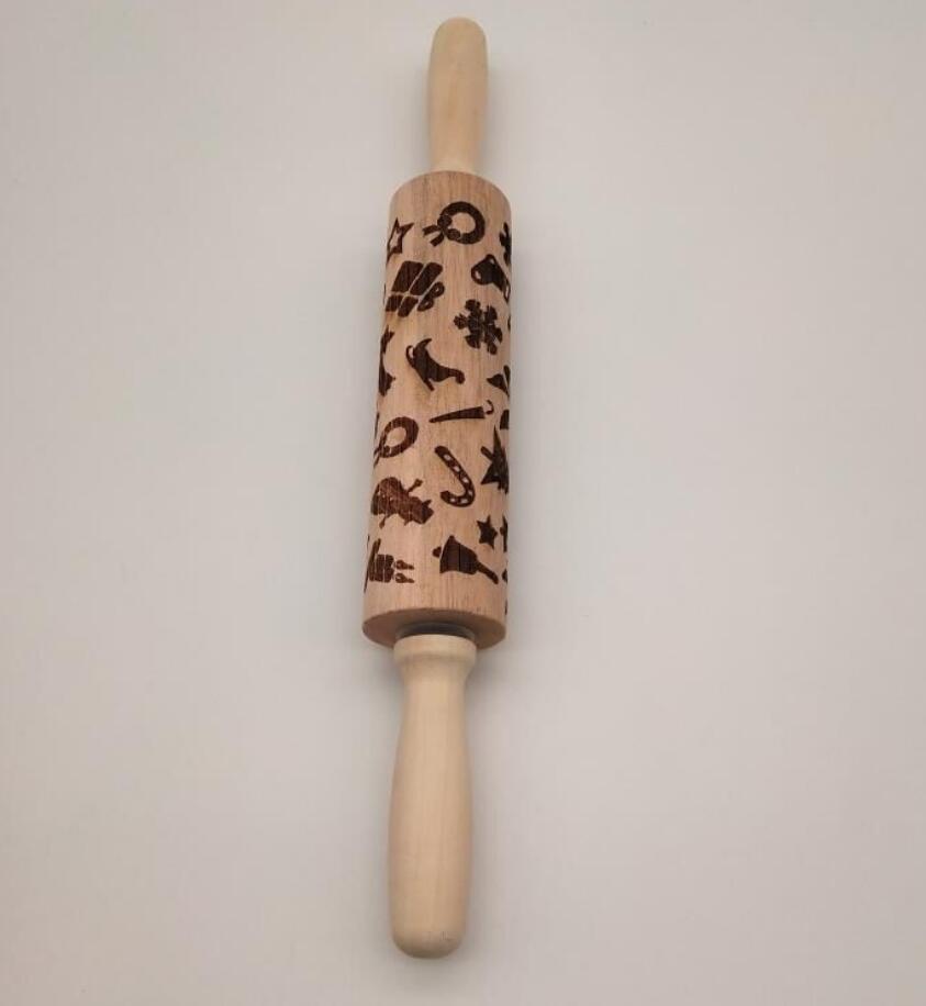 Shopi Vella Christmas embossing rolling pin with festive holiday patterns on wooden surface