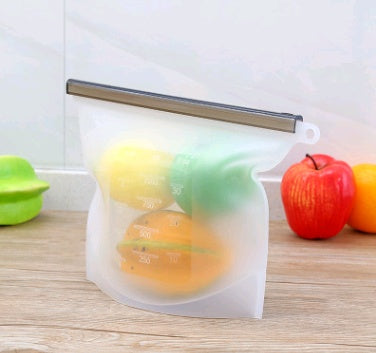 Shopi Vella silicone food storage bag holding fresh fruits on wooden kitchen counter