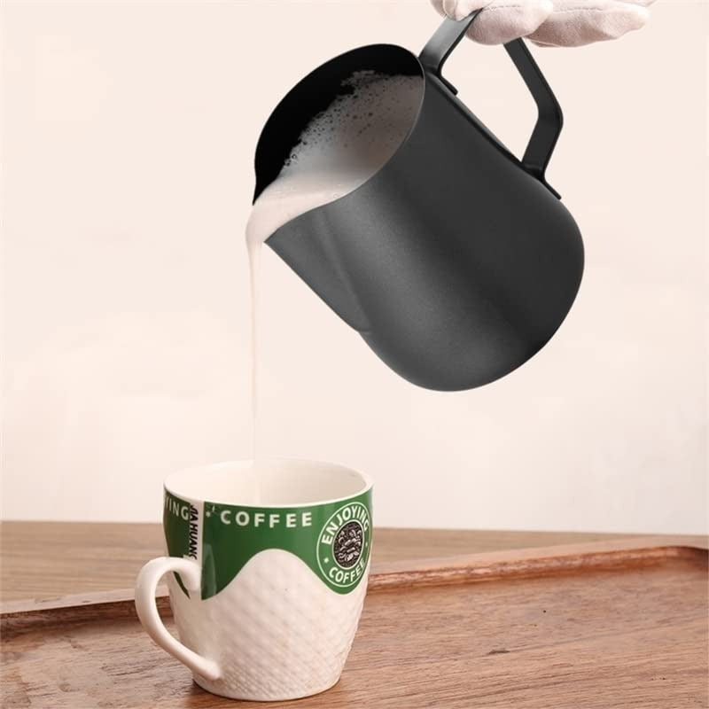 Shopi Vella stainless steel milk frother jug pouring frothed milk into coffee cup on wooden tray