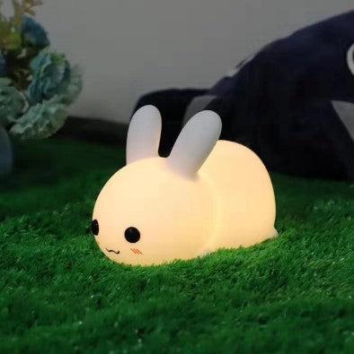 Colorful rabbit silicone night light glowing softly on green grass indoor decor