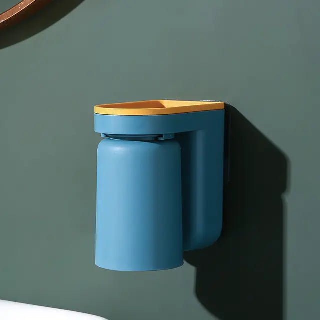 Modern blue and yellow wall-mounted toothbrush holder attached to green bathroom wall