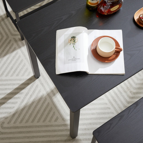 Shopi Vella compact dining set for small spaces with black table and matching bench on patterned rug