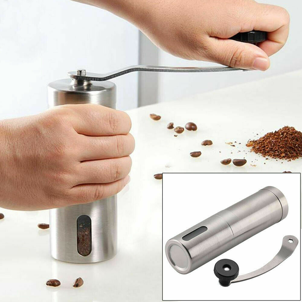 Shopi Vella conical burr coffee bean mill being hand-cranked with stainless steel body and ground coffee