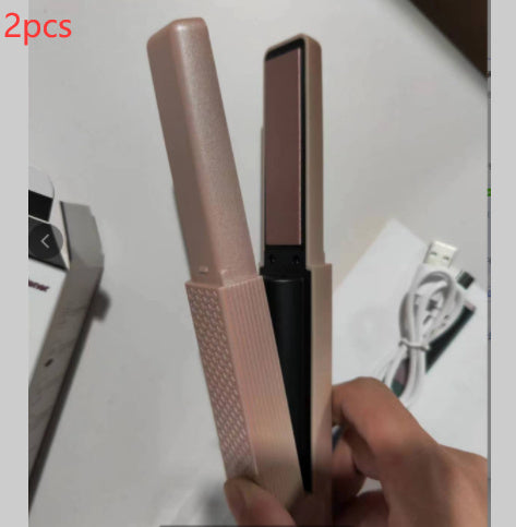 Shopi Vella cordless hair straightener for travel in pink with USB charging cable shown in hand