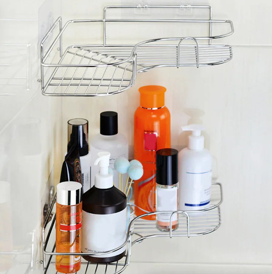 Chrome corner shower caddy shelf mounted in shower holding various bottles and toiletries