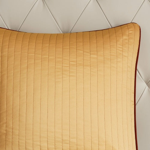 Close-up of mustard yellow pillow from cotton bed sheets comforter set with quilted stripes