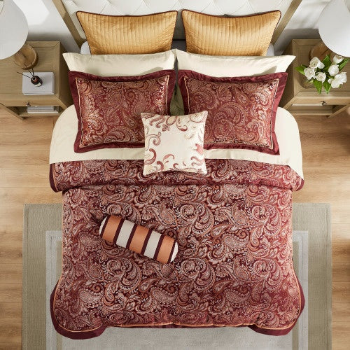 Cotton bed sheets comforter set with intricate red paisley pattern and matching pillows on bed