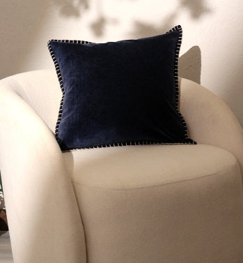 Shopi Vella navy blue cotton velvet throw pillow case on beige armchair with stitched edges