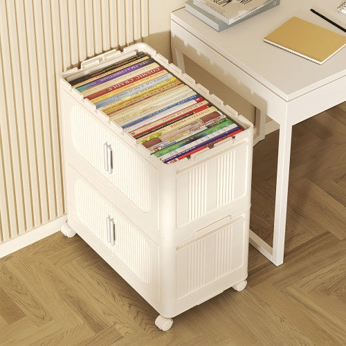 Shopi Vella cream white folding storage cabinet with two compartments and caster wheels beside a desk