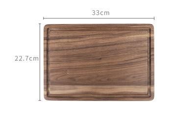 Creative wood cutting board for kitchen by Shopi Vella with smooth rectangular walnut surface and groove