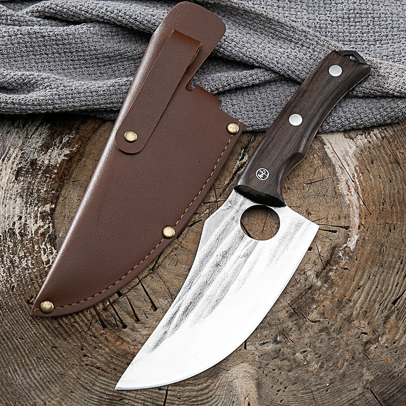 Shopi Vella kitchen deboning knife with wooden handle and leather sheath on wooden surface