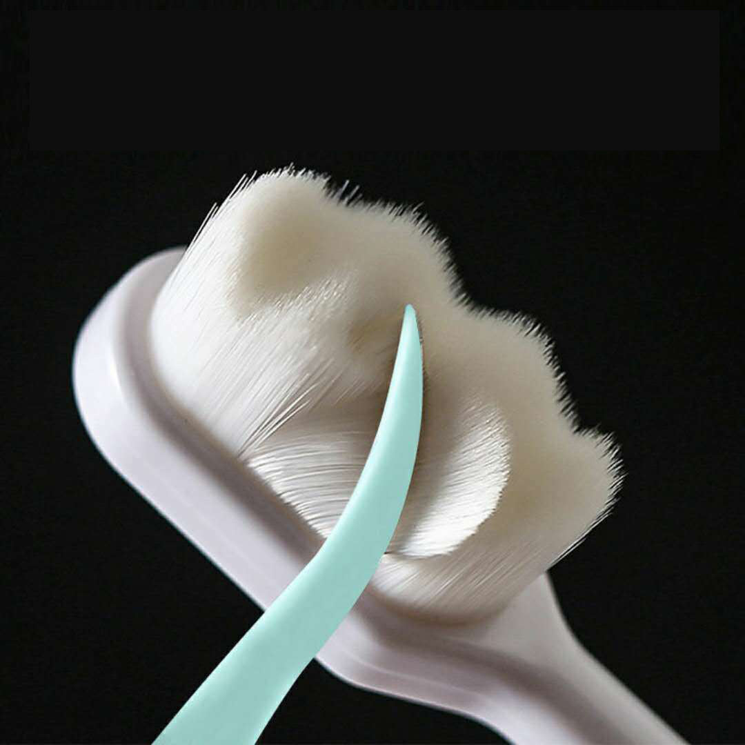 Close-up of soft bristles on a deep cleaning toothbrush for travel by Shopi Vella in white and mint