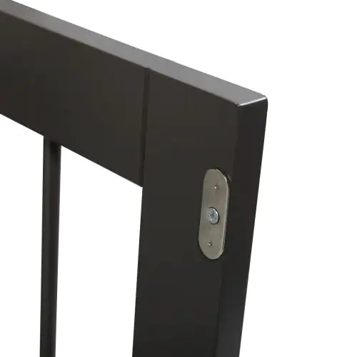 Close-up of sturdy dark metal frame corner on a dog kennel end table