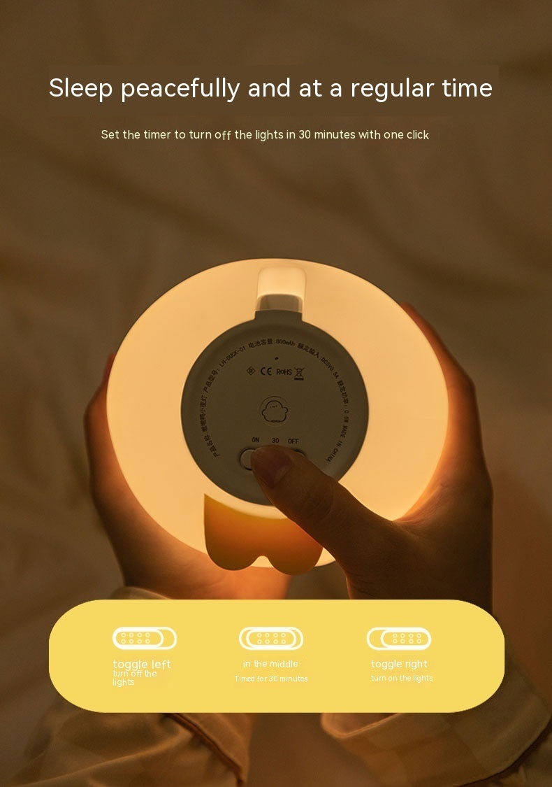 Hand holding Shopi Vella cartoon LED sleeping light showing back control panel with timer and toggle buttons