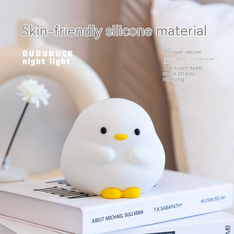 Shopi Vella cartoon LED sleeping light shaped like a cute white duck with yellow feet on a book