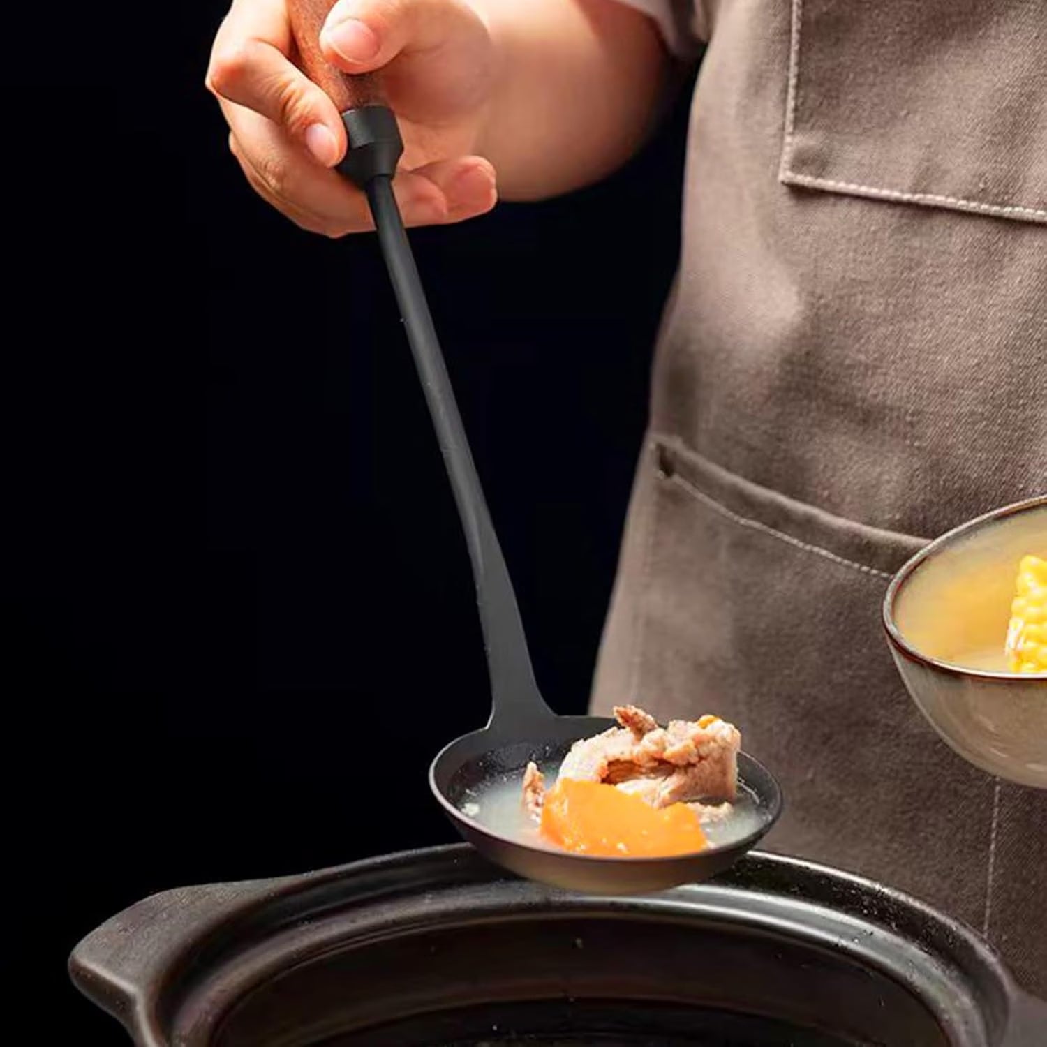 Shopi Vella durable kitchen cookware spoon lifting soup with meat and vegetables over a pot