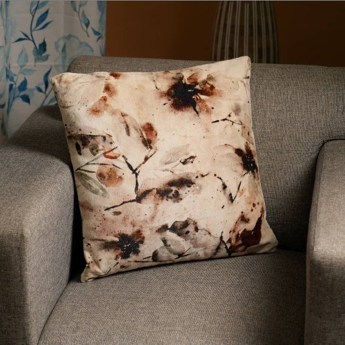 Shopi Vella 18 inch cotton pillow case with floral watercolor design on gray sofa