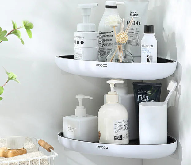 White wall-mounted bathroom storage rack with two shelves holding shampoo, soap dispensers, and toiletries
