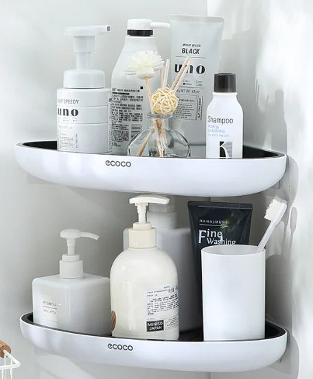 White wall-mounted bathroom storage rack holding toiletries like shampoo, lotion, and toothbrush holder
