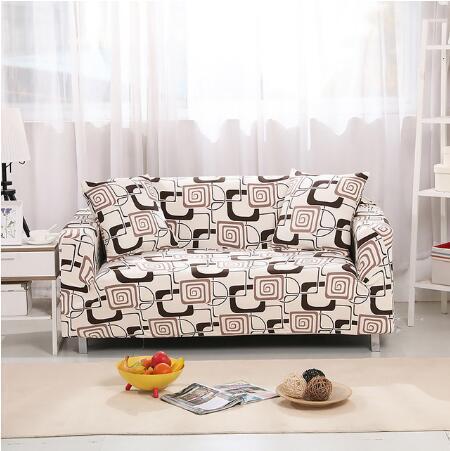 Modern comforter with beige and brown pattern used as an elastic sofa cover on a two-seater sofa