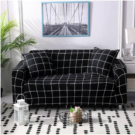 Black and white grid pattern elastic sofa cover on a two-seater sofa with matching cushions in modern living room