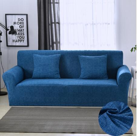 Blue elastic sofa cover fitted on three-seater sofa with matching cushions in modern living room