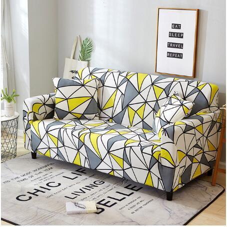 Elastic sofa cover with yellow gray geometric pattern fitted on three-seater couch in modern living room