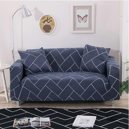 Blue elastic sofa cover with white geometric pattern on a two-seater couch with matching pillows