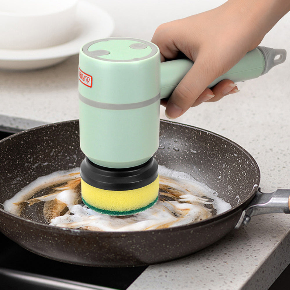 Shopi Vella electric dishwashing brush scrubbing a frying pan with soap foam in kitchen