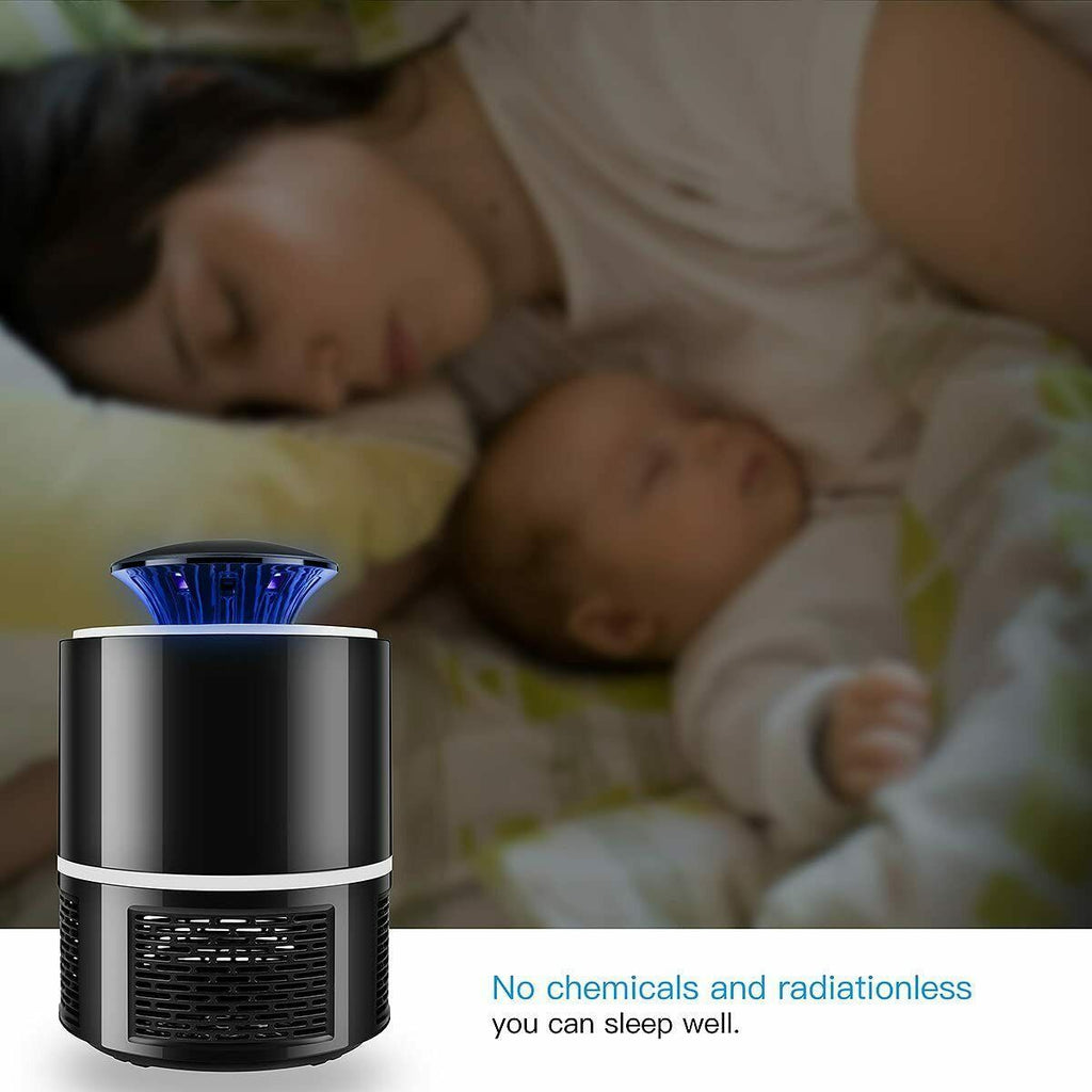 Shopi Vella electric mosquito killer lamp in black with blue light beside sleeping mother and baby