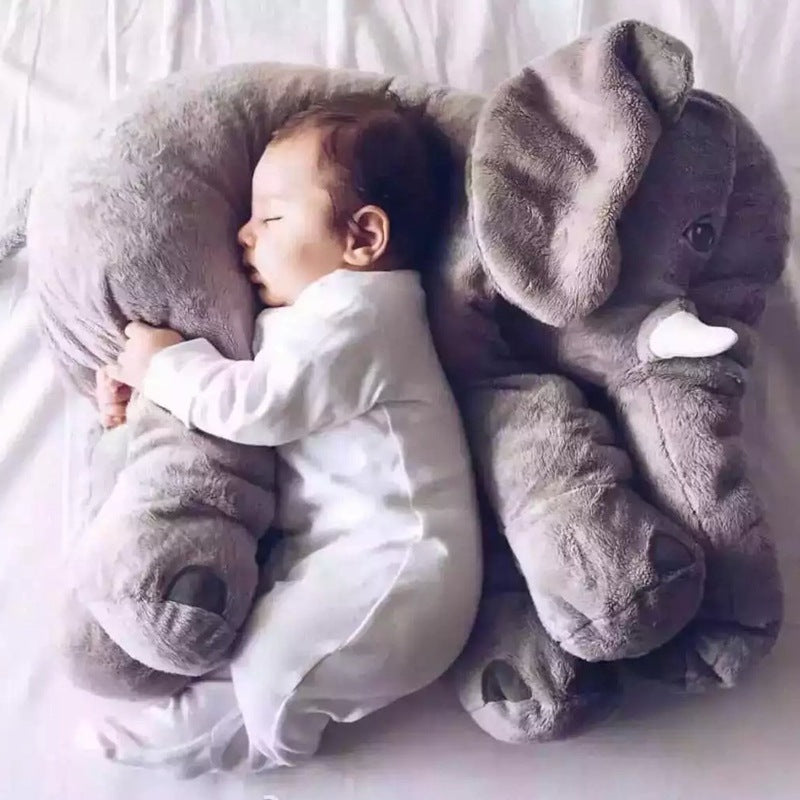 Baby sleeping peacefully on soft comfort baby sleep toy pillow case shaped like gray elephant