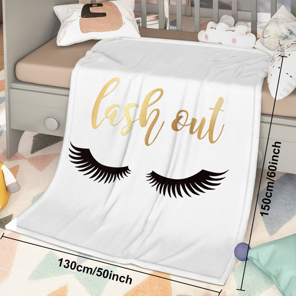 Shopi Vella eyelash print throw blanket with lash out design in a cozy bedroom setting