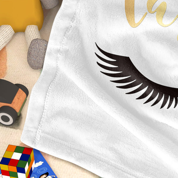 Shopi Vella eyelash print throw blanket in white with black eyelash design on soft fabric