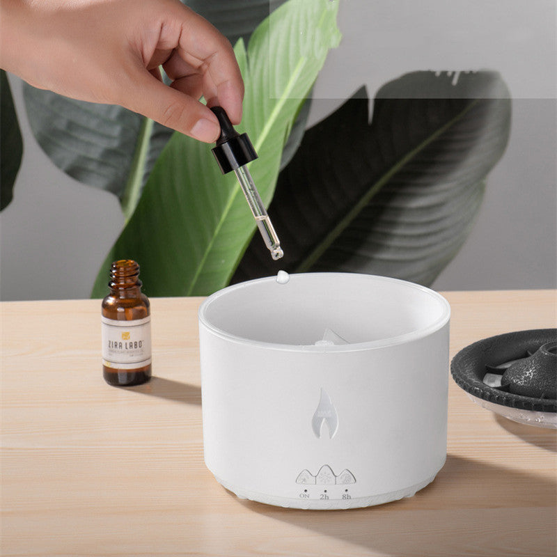 Shopi Vella color changing humidifier with night light in white with essential oil dropper on wooden table