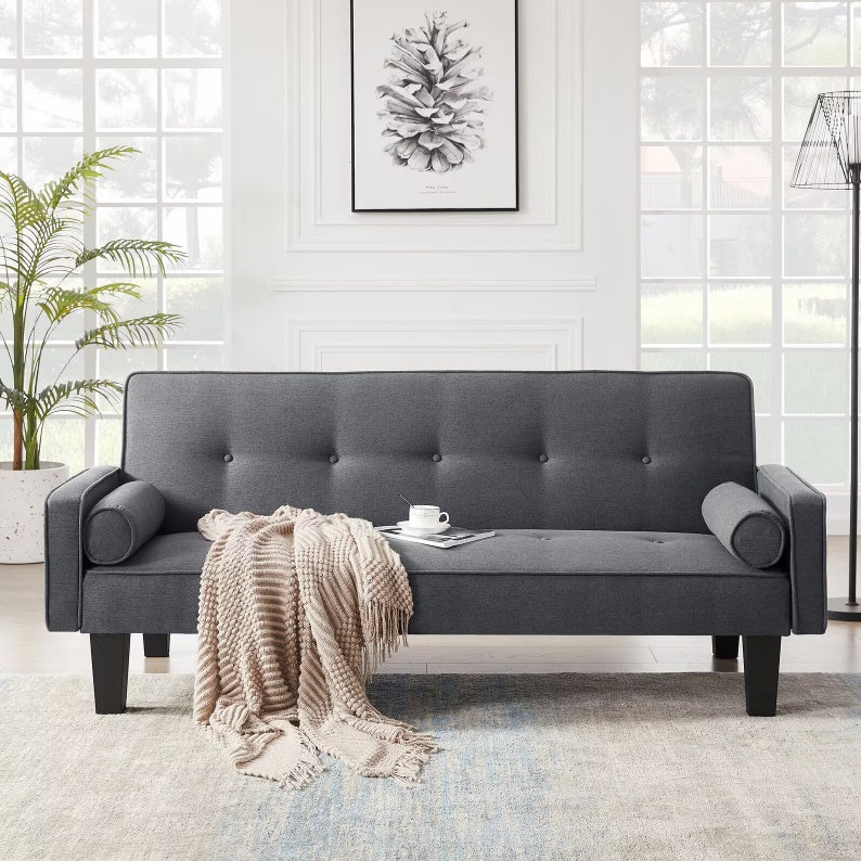 Shopi Vella fabric button tufted living room sofa in dark gray with cylindrical pillows and beige throw blanket