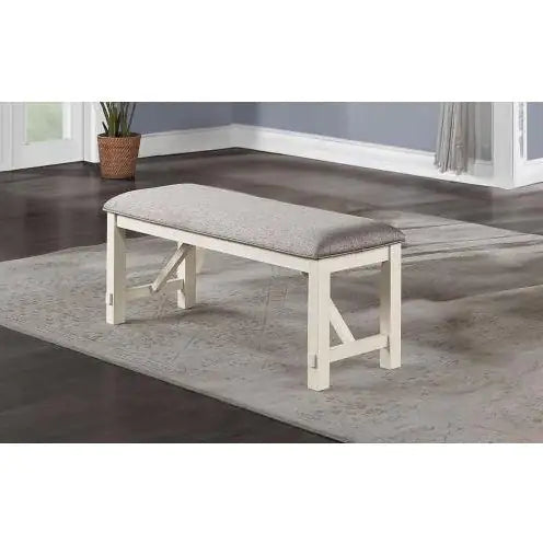 White wooden bench with fabric cushioned dining seating in a modern dining room setting